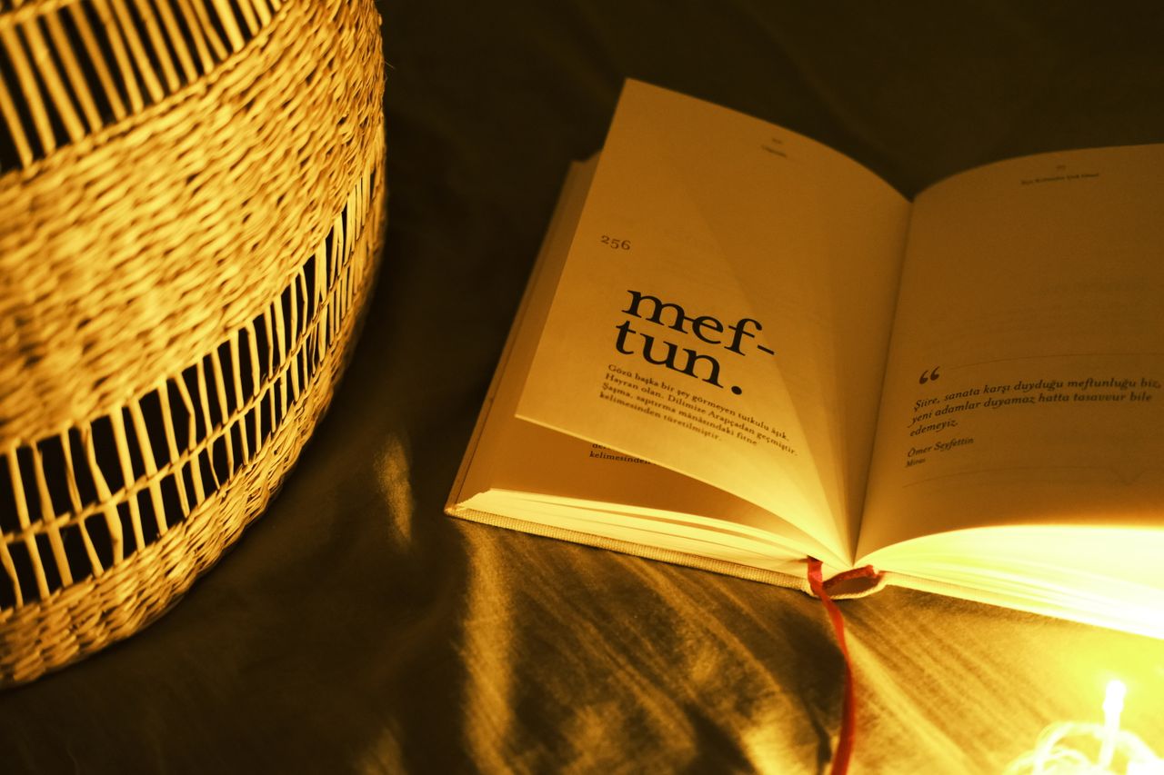 Open book under warm light, perfect for a cozy reading ambiance.